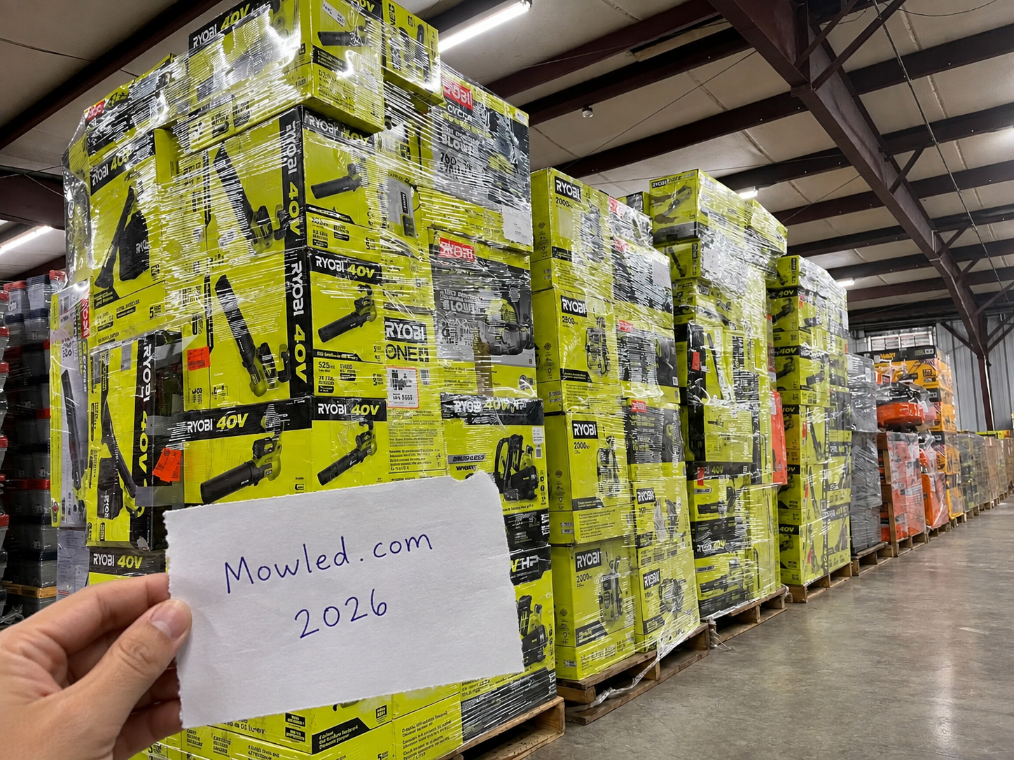 Pallets of outdoor power equipment in the Mowled warehouse
